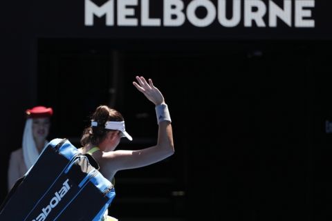 Spain's Garbine Muguruza waves as she leaves Rod Laver Arena following her second round loss to Taiwan's Hsieh Su-wei at the Australian Open tennis championships in Melbourne, Australia, Thursday, Jan. 18, 2018. (AP Photo/Vincent Thian)