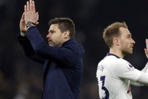 Tottenham manager Mauricio Pochettino, left, and Tottenham's Christian Eriksen applaud the fans at the end of the English Premier League soccer match betweenTottenham Hotspur and Crystal Palace, the first Premiership match at the new Tottenham Hotspur stadium in London, Wednesday, April 3, 2019. Tottenham won 2-0. (AP Photo/Kirsty Wigglesworth)