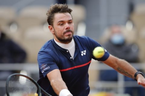 Switzerland's Stan Wawrinka plays a shot against Britain's Andy Murray in the first round match of the French Open tennis tournament at the Roland Garros stadium in Paris, France, Sunday, Sept. 27, 2020. (AP Photo/Christophe Ena)