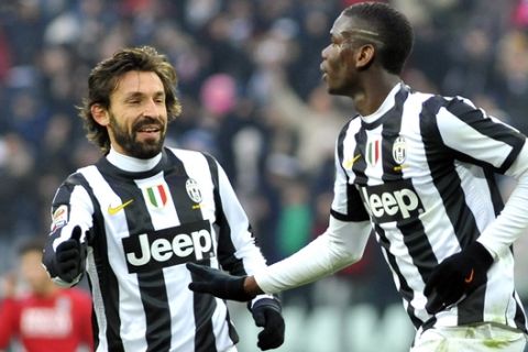 Juventus' Paul Pogba, of France, left, celebrates with his teammate Andrea Pirlo after scoring during a Serie A soccer match between Juventus and Siena at the Juventus Stadium in Turin, Italy, Sunday, Feb 24, 2013. (AP Photo/Massimo Pinca)