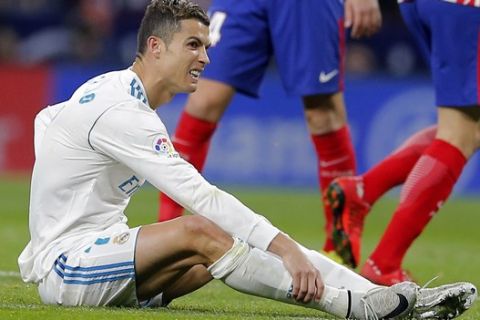 Real Madrid's Cristiano Ronaldo reacts after a tackle during a Spanish La Liga soccer match between Atletico Madrid and Real Madrid at the Metropolitano stadium in Madrid, Spain, Saturday, Nov. 18, 2017. (AP Photo/Paul White)
