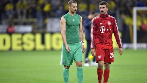 Bayern goalkeeper Manuel Neuer, left, and Bayern's Thomas Muller react after the German Supercup final soccer match between Borussia Dortmund and Bayern Munich in Dortmund, Germany, Saturday, Aug. 3, 2019. (AP Photo/Martin Meissner)
