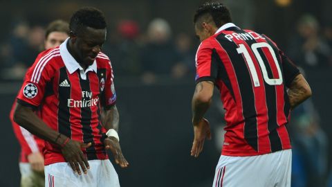 AC Milan's midfielder of Ghana Sulley Ali Muntari (L) celebrates after scoring during the Champions League football match between AC Milan and FC Barcelona on February 20, 2013 at San Siro Stadium in Milan. AFP PHOTO / GIUSEPPE CACACE        (Photo credit should read GIUSEPPE CACACE/AFP/Getty Images)