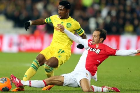 Nantes french forward Serge Gakpe is tackled by Monaco's defender Ricardo Carvalho during their French League One soccer match, Sunday, Nov. 24, 2013 in Nantes, western France. (AP Photo/David Vincent)