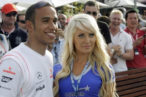 McLaren Mercedes Formula One driver Lewis Hamilton of Britain poses for a photo with a grid girl after the qualifying for the Australian Grand Prix at the Albert Park circuit in Melbourne, Australia, Saturday, March 15, 2008. Hamilton was quickest in front of BMW Sauber driver Robert Kubica of Poland and teammate Heikki Kovalainen of Finland. (AP Photo/Rob Griffith)