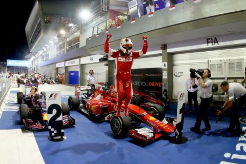 SINGAPORE - SEPTEMBER 20:  Sebastian Vettel of Germany and Ferrari celebrate sin Parc Ferme after winning the Formula One Grand Prix of Singapore at Marina Bay Street Circuit on September 20, 2015 in Singapore.  (Photo by Clive Rose/Getty Images)