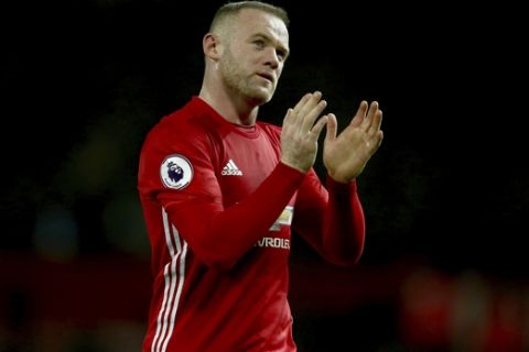 FILE - A Sunday, Jan. 15, 2017 file photo of Manchester United's Wayne Rooney leaving the field after the English Premier League soccer match between Manchester United and Liverpool at Old Trafford stadium in Manchester, England. Manchester United captain Wayne Rooney says he raised 1.2 million pounds ($1.5 million) for charity from a friendly game against former club Everton last year. (AP Photo/Dave Thompson)