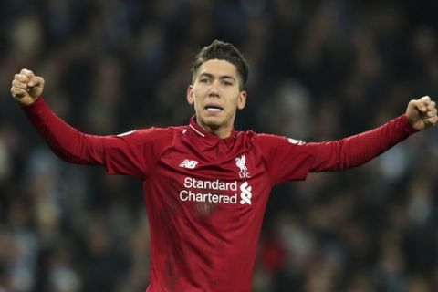 Liverpool's Roberto Firmino celebrates after scoring his sides 1st goal during their English Premier League soccer match between Manchester City and Liverpool at the Ethiad stadium, Manchester England, Thursday, Jan. 3, 2019. (AP Photo/Jon Super)