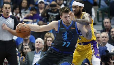Dallas Mavericks forward Luka Doncic (77), of Germany, dribbles against Los Angeles Lakers forward Brandon Ingram (14) during the first quarter of an NBA basketball game in Dallas, Monday, Jan. 7, 2019. (AP Photo/LM Otero)