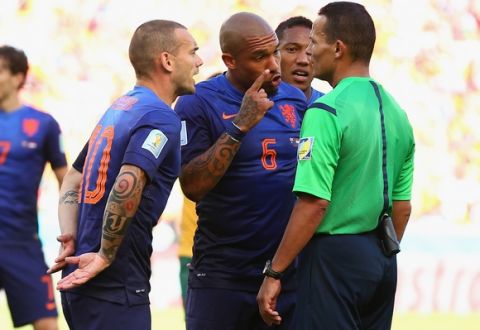 PORTO ALEGRE, BRAZIL - JUNE 18: Wesley Sneijder and Daley Blind of the Netherlands protest a call by Referee Djamel Haimoudi resulting in a penalty kick for Australia during the 2014 FIFA World Cup Brazil Group B match between Australia and Netherlands at Estadio Beira-Rio on June 18, 2014 in Porto Alegre, Brazil.  (Photo by Cameron Spencer/Getty Images)