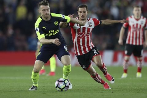 Southampton's Cedric Soares, right, competes for the ball with Arsenal's Aaron Ramsey during the English Premier League soccer match between Southampton and Arsenal at St Mary's stadium in Southampton, England, Wednesday, May 10, 2017. (AP Photo/Alastair Grant)