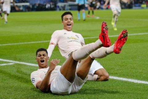 ManU's Marcus Rashford , bottom, celebrates after scoring his side's third goalduring the Champions League round of 16, second leg soccer match between Paris Saint Germain and Manchester United at the Parc des Princes stadium in Paris, France, Wednesday, March. 6, 2019. (AP Photo/Francois Mori)