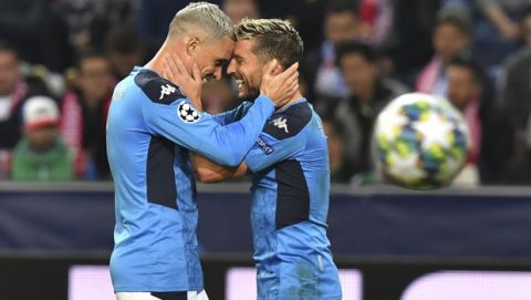 Napoli's Dries Mertens, right, celebrates with teammate Napoli's Jose Callejon after scoring his side's second goal during the Champions League Group E soccer match between FC Red Bull Salzburg and Napoli in Salzburg, Austria, Wednesday, Oct. 23, 2019. (AP Photo/ Kerstin Joensson)
