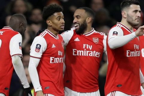 Arsenal's Reiss Nelson, second left, celebrates with teammates after scoring his side's first goal during the English FA Cup soccer match between Arsenal and Leeds United at the Emirates Stadium in London, Monday, Jan. 6, 2020.(AP Photo/Kirsty Wigglesworth)