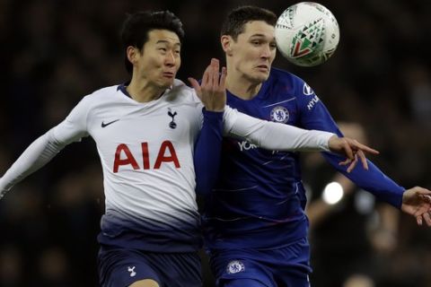 Tottenham's Son Heung-min, left, challenges with Chelsea's Andreas Christensen during the English League Cup semifinal first leg soccer match between Tottenham Hotspur and Chelsea at Wembley Stadium in London, Tuesday, Jan. 8, 2019. (AP Photo/Kirsty Wigglesworth)