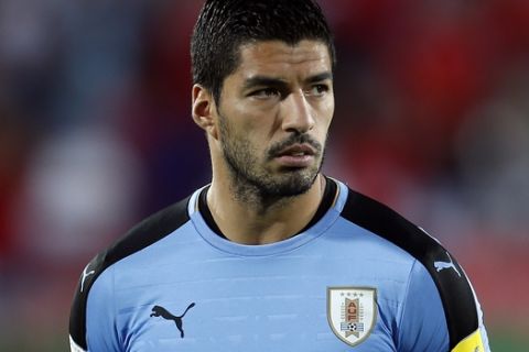 Uruguay's Luis Suarez, stands on the field during a ceremony before a 2018 World Cup qualifying soccer match against Chile in Santiago, Chile, Tuesday, Nov. 15, 2016. (AP Photo/Luis Hidalgo)