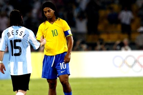 Brazil's Ronaldinho (10) and Argentina's Lionel Messi shake hands after Argentina won 3-0 in a men's semifinal soccer match at the Beijing 2008 Olympics in Beijing, Tuesday, Aug. 19, 2008. (AP Photo/Luca Bruno)