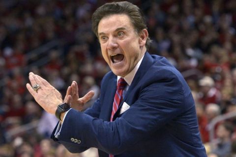 FILE - In this Feb. 17, 2016, file photo, Louisville coach Rick Pitino sends a play in to his team during an NCAA college basketball game against Syracuse in Louisville Ky. Pitino, then coaching at Providence, embraced the 3-point shot immediately after it was added to college basketball in 1986. The Friars went to the 1987 Final Four behind sharpshooter Billy Donovan and their ability to knock down the 3. (AP Photo/Timothy D. Easley, File)