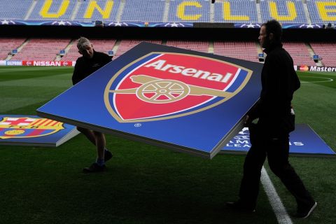 "BARCELONA, SPAIN - MARCH 16:  UEFA signage crew remove the Arsenal crest after a rehersal ahead of the UEFA Champions League Round of 16 second leg match between FC Barcelona and Arsenal FC at Camp Nou stadium on March 16, 2016 in Barcelona, Spain.  (Photo by Denis Doyle - UEFA/UEFA via Getty Images)"