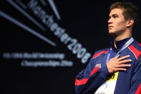 Nathan Adrian of the United States stands on the podium during the national anthem after winning the gold medal in the final of the Men's 100m freestyle at the World Short Course Swimming Championships at the MEN Arena in Manchester, England, Sunday April 13, 2008.   (AP Photo/Paul Thomas)