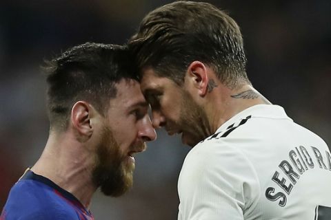 Barcelona forward Lionel Messi, left, goes head to head with Real defender Sergio Ramos after they argue during the Spanish La Liga soccer match between Real Madrid and FC Barcelona at the Bernabeu stadium in Madrid, Saturday, March 2, 2019. (AP Photo/Manu Fernandez)