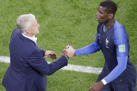 France's Paul Pogba, right, greets France head coach Didier Deschamps as he leaves the field after being substituted during the group C match between France and Peru at the 2018 soccer World Cup in the Yekaterinburg Arena in Yekaterinburg, Russia, Thursday, June 21, 2018. (AP Photo/Mark Baker)