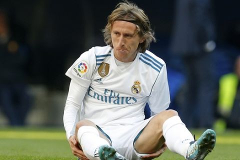 In this photo taken on Dec. 23, 2017, Real Madrid's Luka Modric sits on the pitch after falling during the Spanish La Liga soccer match between Real Madrid and Barcelona at the Santiago Bernabeu stadium in Madrid, Spain. Croatia midfielder Luka Modric has appeared in court in a tax fraud case in Madrid on Tuesday Jan. 9, 2018, accused of defrauding tax authorities of 870,728 euros (about 1 million dollars) in 2013 and 2014. Local newspaper El Mundo said Modric has already paid nearly 1 million (1.2 million dollars) to tax authorities to try to reach a settlement. (AP Photo/Paul White)