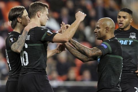 Krasnodar's Viktor Claesson, second left, celebrates with teammates after scoring his side's opening goal during the Europa League round of 16, first leg soccer match between Valencia and FC Krasnodar at the Mestalla Stadium in Valencia, Spain, Thursday, March 7, 2019. (AP Photo/Alberto Saiz)