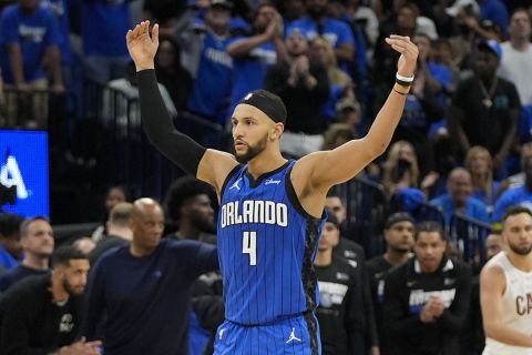 Orlando Magic guard Jalen Suggs (4) waves his arms to get the fans cheering during the second half of Game 6 of an NBA basketball first-round playoff series against the Cleveland Cavaliers, Friday, May 3, 2024, in Orlando, Fla. (AP Photo/John Raoux)