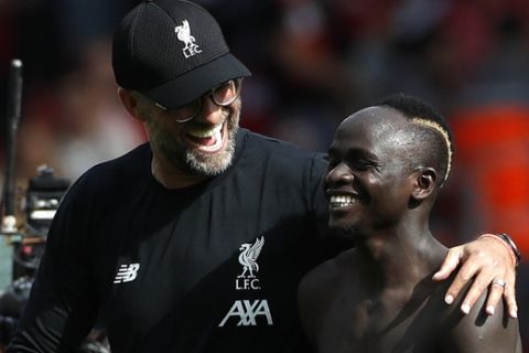 Liverpool's manager Jurgen Klopp, left, celebrates with Liverpool's Sadio Mane after the English Premier League soccer match between Liverpool and Newcastle at Anfield stadium in Liverpool, England, Saturday, Sept. 14, 2019. (AP Photo/Rui Vieira)