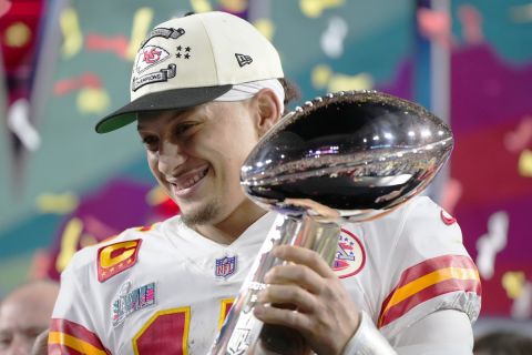 Kansas City Chiefs quarterback Patrick Mahomes (15) holds the trophy after their win against the Philadelphia Eagles in the NFL Super Bowl 57 football game, Sunday, Feb. 12, 2023, in Glendale, Ariz. The Kansas City Chiefs defeated the Philadelphia Eagles 38-35. (AP Photo/Matt Slocum)