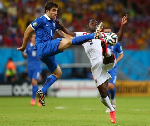 RECIFE, BRAZIL - JUNE 29:  Sokratis Papastathopoulos of Greece challenges Joel Campbell of Costa Rica during the 2014 FIFA World Cup Brazil Round of 16 match between Costa Rica and Greece at Arena Pernambuco on June 29, 2014 in Recife, Brazil.  (Photo by Quinn Rooney/Getty Images)