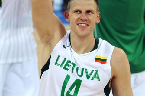 Lithuania's Marijonas Petravicius celebrates his team won the men's preliminary round group A basketball match Lithuania vs Argentina at the Olympic basketball gymnasium during the 2008 Beijing Olympic Games on August 10, 2008. Lithuania won 79-75. AFP PHOTO/GABRIEL BOUYS   