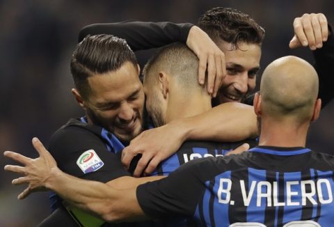 Inter's captain Mauro Icardi, center, celebrates with teammates Danilo D'Ambrosio, left, Roberto Gagliardini and Borja Valero, right, after scoring his side's third goal during an Italian Serie A soccer match between Inter Milan and Sampdoria, at the San Siro stadium in Milan, Italy, Tuesday, Oct. 24, 2017. (AP Photo/Luca Bruno)