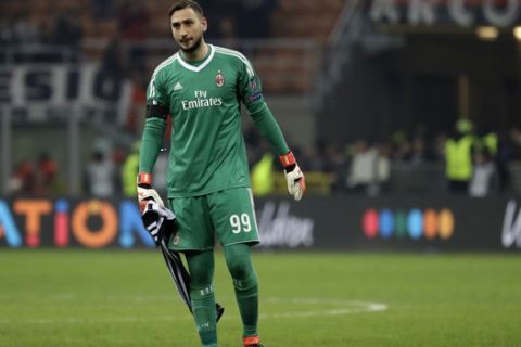 AC Milan goalkeeper Gianluigi Donnarumma walks on the pitch at the end of the Europa League round of 16 first-leg soccer match between AC Milan and Arsenal, at the Milan San Siro Stadium, Italy, Thursday, March 8, 2018. The match finished 0-2. (AP Photo/Luca Bruno)