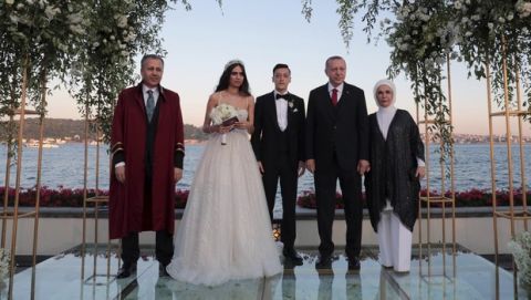 Turkey's President Recep Tayyip Erdogan, second right, Turkish-German soccer player Mesut Ozil, center, his wife Amine Gulse, second left, Erdogan's wife Emine Erdogan and Istanbul Governor and temporary mayor Ali Yerlikaya pose for a photo during a wedding ceremony over the Bosporus in Istanbul, Friday, June 7, 2019.(Presidential Press Service via AP, Pool)