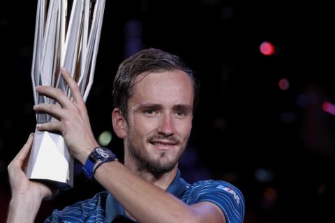 Daniil Medvedev of Russia poses with his winner's trophy after defeating Alexander Zverev of Germany in the men's final at the Shanghai Masters tennis tournament at Qizhong Forest Sports City Tennis Center in Shanghai, China, Sunday, Oct. 13, 2019. (AP Photo/Andy Wong)