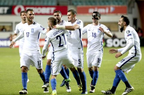 Greece's Konstantionos Stafylidis, center right, celebrates his goal with teammates during their World Cup Group H qualifying soccer match between Estonia and Greece in Tallinn, Estonia, on Tuesday, March 29, 2016. (AP Photo/Liis Treimann)