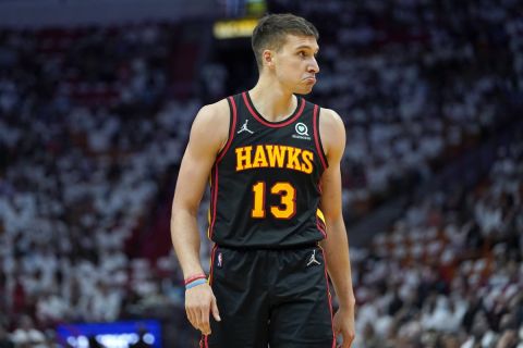 Atlanta Hawks guard Bogdan Bogdanovic (13) walks on the court during the first half of Game 1 of an NBA basketball first-round playoff series against the Miami Heat, Sunday, April 17, 2022, in Miami. (AP Photo/Lynne Sladky)