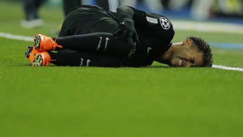 PSG's Neymar lies on the pitch after being fouled during the Champions League soccer match, round of 16, 1st leg between Real Madrid and Paris Saint Germain at the Santiago Bernabeu stadium in Madrid, Spain, Wednesday, Feb. 14, 2018. (AP Photo/Paul White)