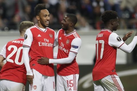 Arsenal's Pierre-Emerick Aubameyang, second left, celebrates after scoring his side's third goal during the Europa League Group F soccer match between Eintracht Frankfurt and Arsenal in the Commerzbank Arena in Frankfurt, Germany, Thursday, Sept. 19, 2019. (AP Photo/Michael Probst)
