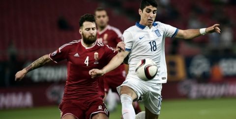Greece's Petros Mantalos (R) vies for the ball with Hungary's Tamas Kadar during the UEFA Euro 2016 qualifying Group F football match between Greece and Hungary at the Stadio Georgios Karaiskakis in Athens on October 11, 2015. AFP PHOTO / ANGELOS TZORTZINIS        (Photo credit should read ANGELOS TZORTZINIS/AFP/Getty Images)