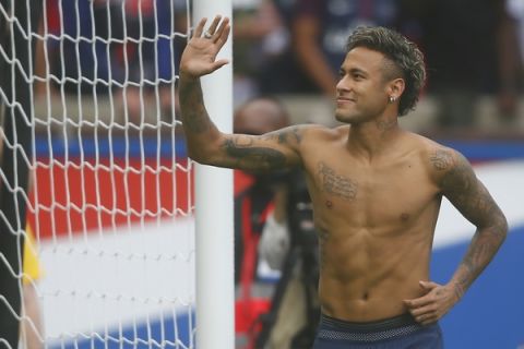 Brazilian soccer star Neymar salutes his fans at the Parc des Princes stadium in Paris, Saturday, Aug. 5, 2017, during his official presentation to fans ahead of Paris Saint-Germain's season opening match against Amiens. Neymar would not play in the club's season opener as the French football league did not receive the player's international transfer certificate before Friday's night deadline. The Brazil star became the most expensive player in soccer history after completing his blockbuster transfer from Barcelona for 222 million euros ($262 million) on Thursday. (AP Photo/Francois Mori)