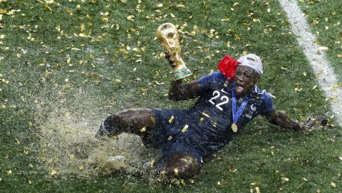 France's Benjamin Mendy celebrates with the trophy after his team won the final match against Croatia at the 2018 soccer World Cup in the Luzhniki Stadium in Moscow, Russia, on July 15, 2018. (AP Photo/Rebecca Blackwell)