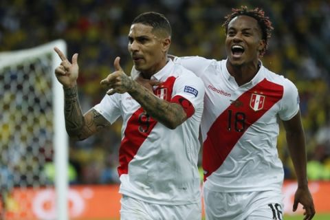 Peru's Paolo Guerrero celebrates with teammate Andre Carrillo, right, after scoring his side first goal against Brazil during the final soccer match of the Copa America at the Maracana stadium in Rio de Janeiro, Brazil, Sunday, July 7, 2019. (AP Photo/Victor R. Caivano)