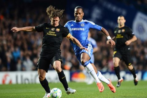 LONDON, ENGLAND - APRIL 18: Didier Drogba of Chelsea closes down Carles Puyol of Barcelona during the UEFA Champions League Semi Final first leg match between Chelsea and Barcelona at Stamford Bridge on April 18, 2012 in London, England.  (Photo by Jasper Juinen/Getty Images)