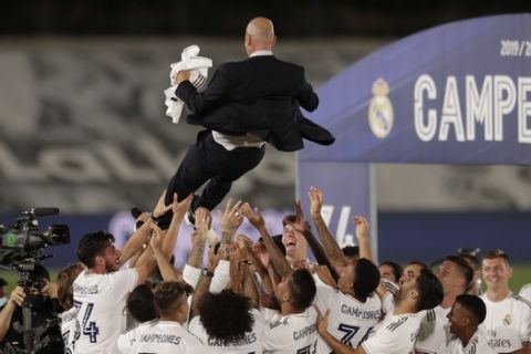 Real Madrid's players throw on the air their head coach Zinedine Zidane, as they celebrate after winning the Spanish La Liga 2019-2020 following a soccer match between Real Madrid and Villareal at the Alfredo di Stefano stadium in Madrid, Spain, Thursday, July 16, 2020. (AP Photo/Bernat Armangue)