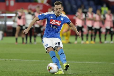 Napoli's Arkadiusz Milik scores the winning penalty kick during the Italian Cup soccer final match between Napoli and Juventus, at Rome's Olympic Stadium, Wednesday, June 17, 2020. (AP Photo/Andrew Medichini)