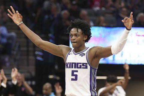 Sacramento Kings guard De'Aaron Fox celebrates after the team scored a 3-point basket during the second half of an NBA basketball game against the Memphis Grizzlies, Wednesday, Oct. 24, 2018, in Sacramento, Calif. The Kings won 97-92. (AP Photo/Rich Pedroncelli)
