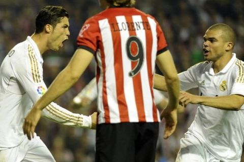 Real Madrid's Portuguese forward Cristiano Ronaldo (L) celebrates with Real Madrid's Portuguese defender Pepe (R) after scoring during the Spanish league football match Athletic Bilbao vs Real Madrid at the San Mames stadium in Bilbao, on May 2, 2012. AFP PHOTO/ RAFA RIVAS        (Photo credit should read RAFA RIVAS/AFP/GettyImages)